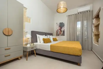 a bedroom with a bed and a dresser and a window at Villa Savina in Plátanos