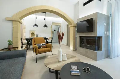 a living room with a couch and a fireplace at Villa Savina in Plátanos