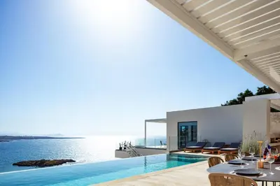 a villa with a swimming pool and a view of the ocean at Casablanca Villa in Chania Town