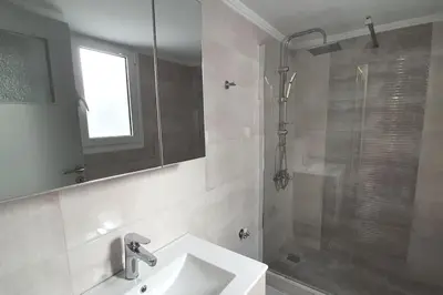 a bathroom with a shower and a sink and a mirror at Charming Apartment In The Heart Of The City Chania in Chania Town