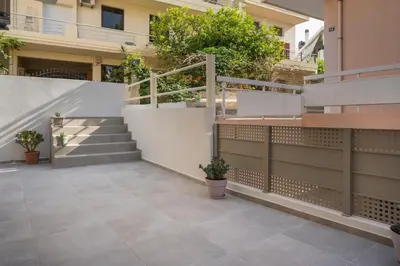 a courtyard of a building with stairs and plants at Casa Amarillo - Halepa in Chania Town
