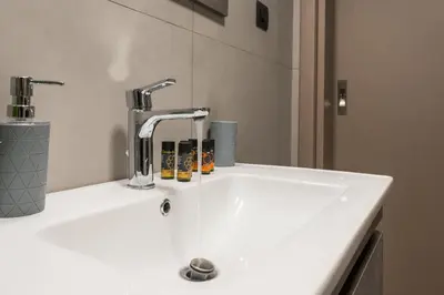 a white sink with a faucet on a counter at Casa Amarillo - Halepa in Chania Town