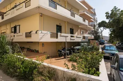 a building with a motorcycle parked in front of it at Casa Amarillo - Halepa in Chania Town