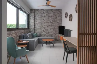 a living room with a couch and a tv at Dedalos City Apartment in Chania Town