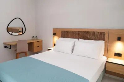 a bedroom with a bed and a desk with a mirror at Dedalos City Apartment in Chania Town