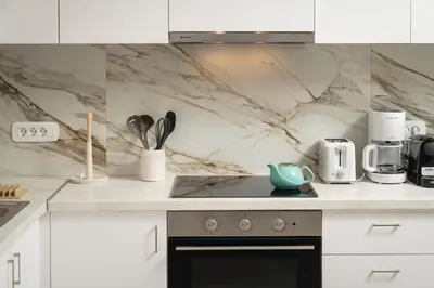 a kitchen with white counters and a stove top oven at Casa Makda in Parigoría