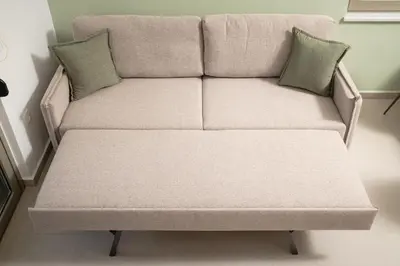 a couch with two pillows on it in a room at Casa Makda in Parigoría