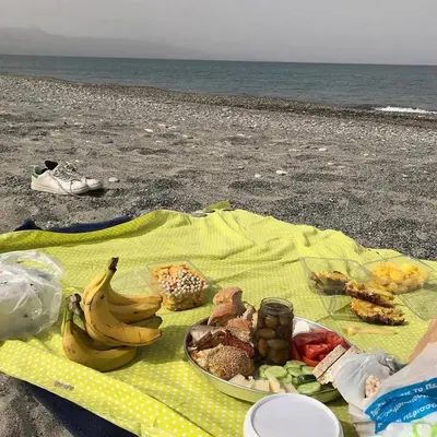 a plate of food on a blanket on the beach at Seamoon in Plataniás