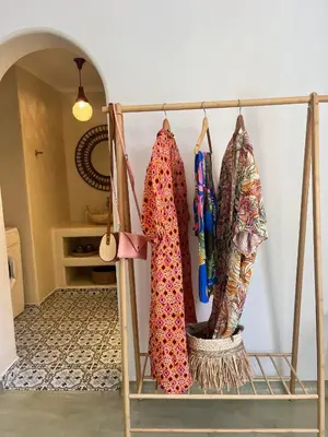 a rack with clothes hanging on a wall at Seamoon in Plataniás