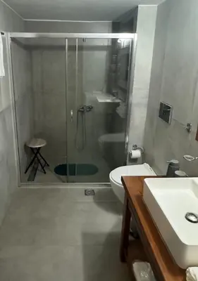a bathroom with a shower and a toilet and a sink at Catherine Apartment in Chania Town