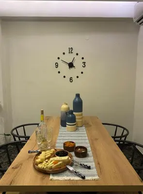 a table with a clock and a plate of food on it at Catherine Apartment in Chania Town
