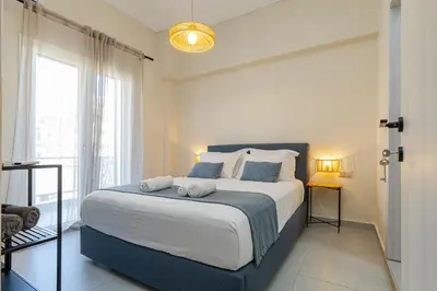 a bedroom with a large bed with towels on it at Jo's Central & Cozy Apartment in Chania Town
