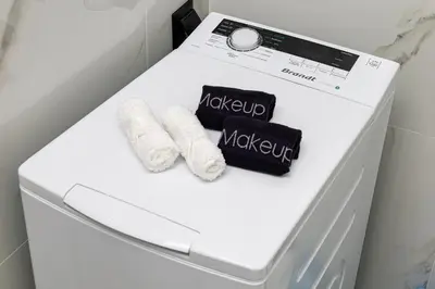 a white refrigerator with two mugs and towels on it at Jo's Central & Cozy Apartment in Chania Town