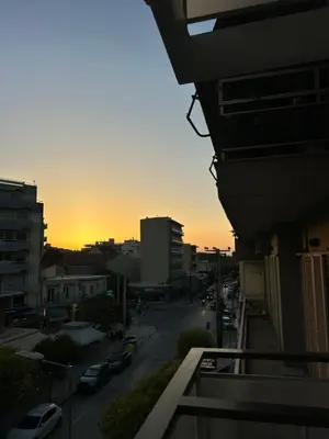 a view from a balcony of a city at sunset at Jo's Central & Cozy Apartment in Chania Town