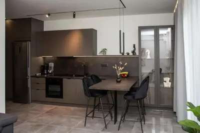 a kitchen with a table and chairs in a room at Celestial Apartments in Chania Town