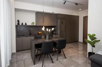 a kitchen and dining room with a table and chairs at Celestial Apartments in Chania Town