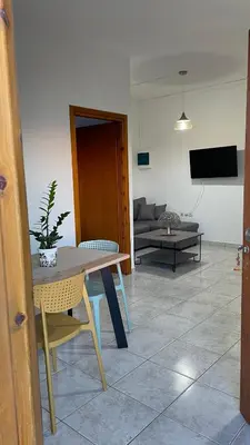 a living room with a table and chairs and a couch at Murele apartments in Daratso