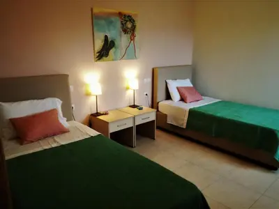 a hotel room with two beds and two lamps at Aksos Suites Accessible Accommodation in Ayiá