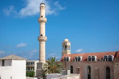 a mosque with two towers in front of a building at Casa Dione - Chania Old Town in Chania Town