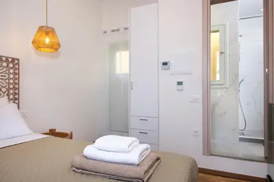 a bedroom with a bed with two towels on it at Casa Dione - Chania Old Town in Chania Town