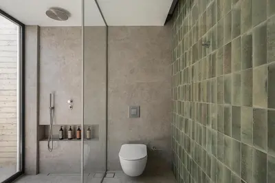 a bathroom with a toilet and a glass shower at Alba Cave Villas in Chania Town