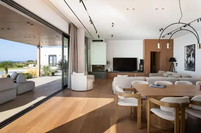 a living room with white furniture and a dining room at Kiyomi Villa in Chania Town