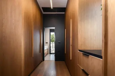 a hallway with wood paneled walls and a hallway with a door at Kiyomi Villa in Chania Town