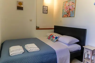 a bedroom with two beds with towels on them at Laurels Apartment in Chania Town