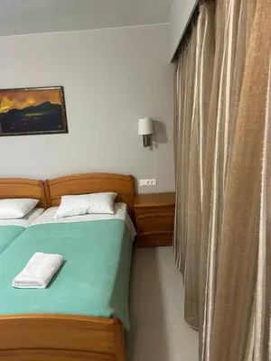 a bedroom with two twin beds and a window at Nektar Beach Hotel in Stalos