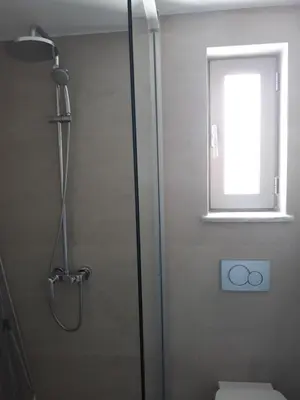 a shower with a glass door in a bathroom at Nektar Beach Hotel in Stalos