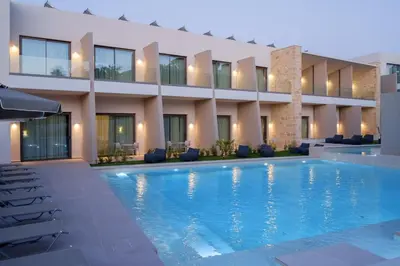 a swimming pool in front of a building at Phos Hotel Adults Only in Plataniás