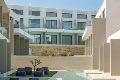 an external view of a building with a swimming pool at Phos Hotel Adults Only in Plataniás