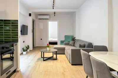 a living room with a couch and a table at Casa in giardino in Chania Town