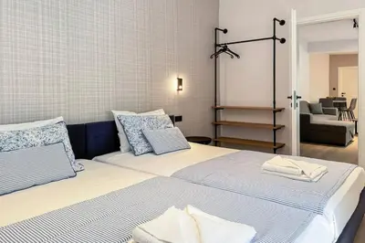 a bedroom with two beds and a living room at Casa in giardino in Chania Town