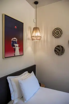 a bedroom with a bed and a picture on the wall at Cozy Rena luxury apartment with free private parking in Chania Town