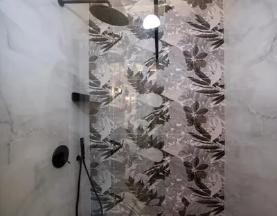 a shower stall with a floral pattern on the wall at Cozy Rena luxury apartment with free private parking in Chania Town