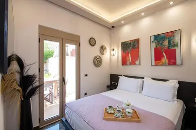 a bedroom with a bed with a tray on it at Cozy Rena luxury apartment with free private parking in Chania Town