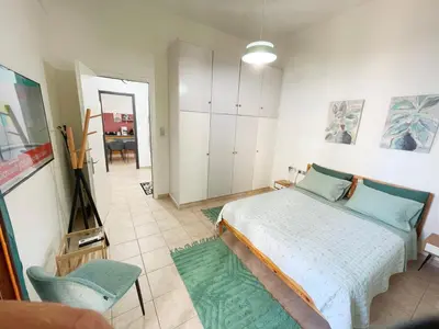 a bedroom with a bed and a living room at NAOS-Sea front vacation rental by Chania center in Chania Town