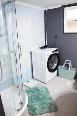 a bathroom with a shower and a washing machine at NAOS-Sea front vacation rental by Chania center in Chania Town