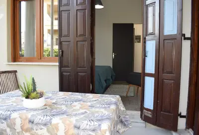a room with a table with a potted plant on it at NAOS-Sea front vacation rental by Chania center in Chania Town