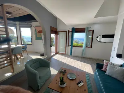 a living room with a couch and a table at NAOS-Sea front vacation rental by Chania center in Chania Town