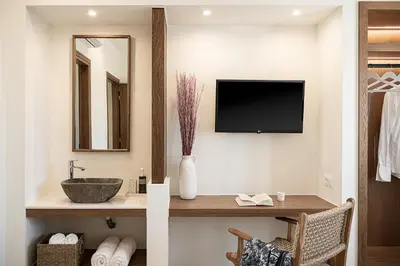 a bathroom with a sink and a tv on a wall at Villa Seyian in Chania Town