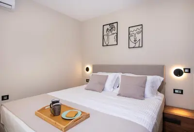 a bedroom with a white bed with a tray on it at Kalopsia Luxury Apartment Near Chania in Chania Town