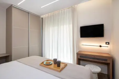 a hotel room with a bed with a tray on it at Kalopsia Luxury Apartment Near Chania in Chania Town