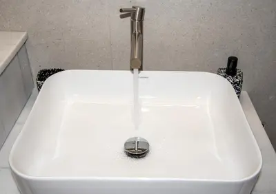 a sink with a drain in the middle of it at Kalopsia Luxury Apartment Near Chania in Chania Town