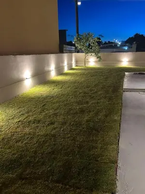 a garden with lights on the side of a building at Kalopsia Luxury Apartment Near Chania in Chania Town