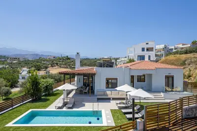 a villa with a swimming pool and a house at Villa Wisdom - Elegant & Homely with Pool, Galatas in Chania Town