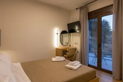 a bedroom with a bed with two towels on it at Villa Wisdom - Elegant & Homely with Pool, Galatas in Chania Town