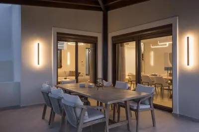 a dining room with a wooden table and chairs at Villa Wisdom - Elegant & Homely with Pool, Galatas in Chania Town