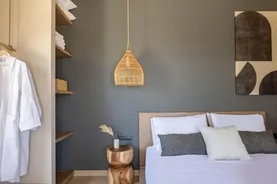 a bedroom with a bed and a pendant light at Yemaya Sea View Villa in Chania Town